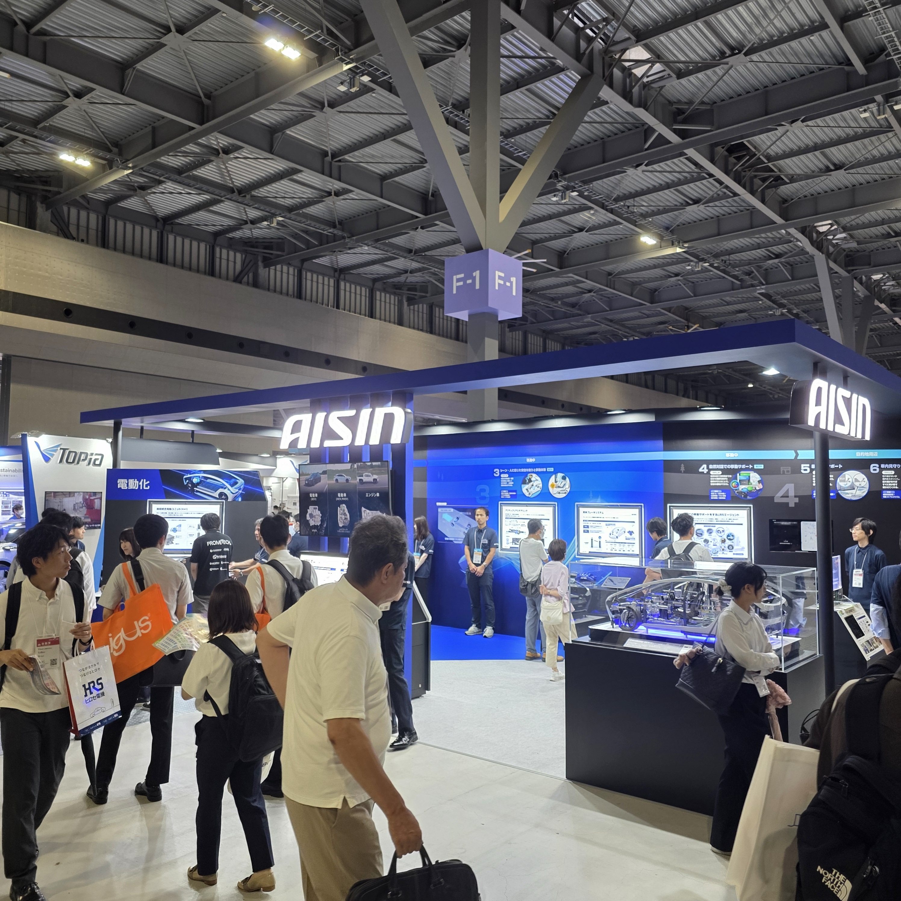 Automotive Engineering Exposition 2025 Nagoya 전시장 전경 — AISIN·TOPia 등 대형 부스와 관람객들