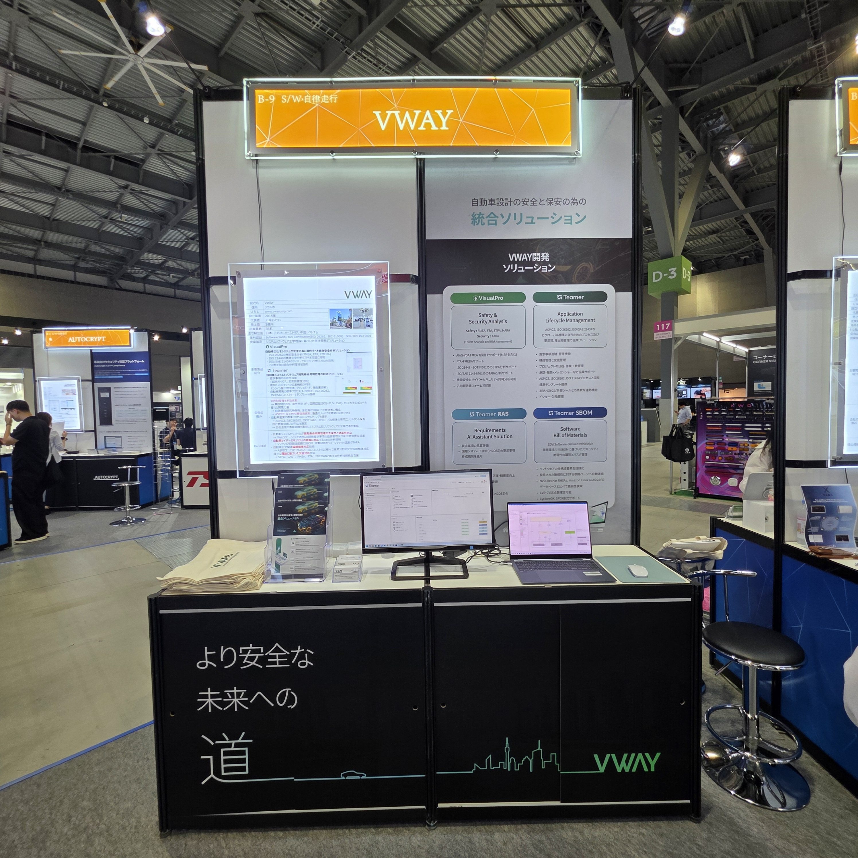Automotive Engineering Exposition 2025 Nagoya 의 브이웨이 부스(B-9, S/W·자율주행) — '자동차 설계의 안전과 보안을 위한 통합 솔루션' 패널에 VisualPro(Safety & Security Analysis), Teamer(Application Lifecycle Management), Teamer RAS(Requirements AI Assistant Solution), Teamer SBOM(Software Bill of Materials) 소개. 부스 앞면에 'より安全な未来への道'(보다 안전한 미래로 가는 길)