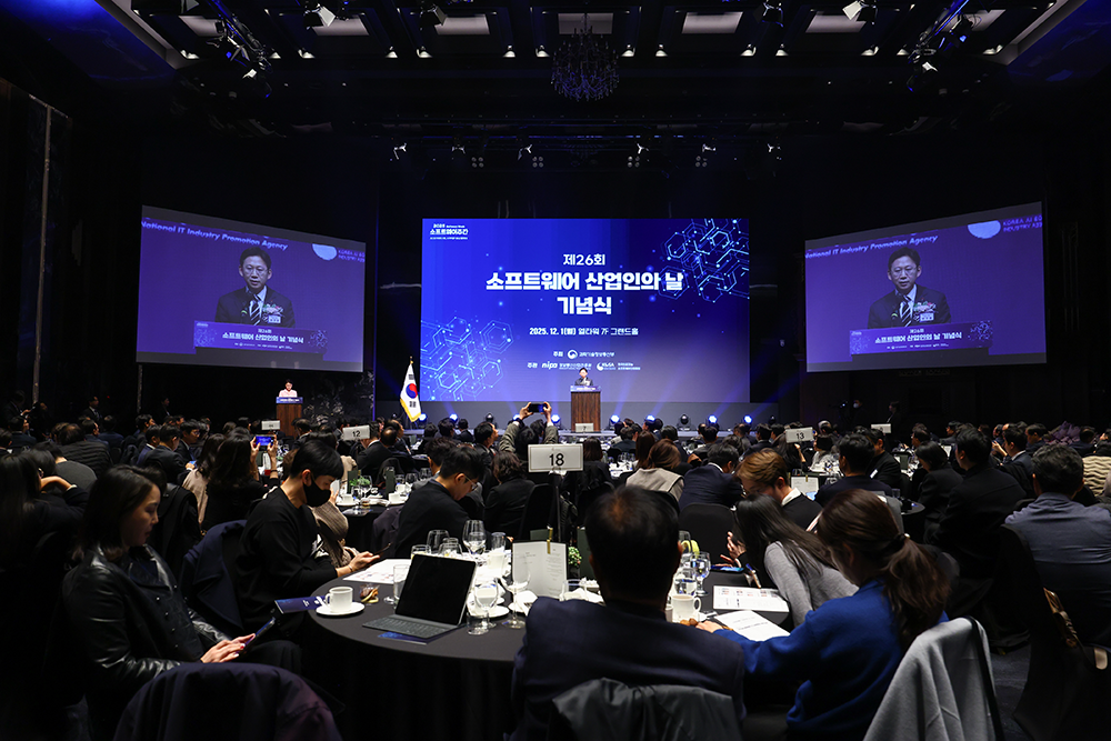 제26회 소프트웨어 산업인의 날 기념식 행사장 — 무대 화면과 좌우 대형 스크린, 자리를 가득 채운 참석자
